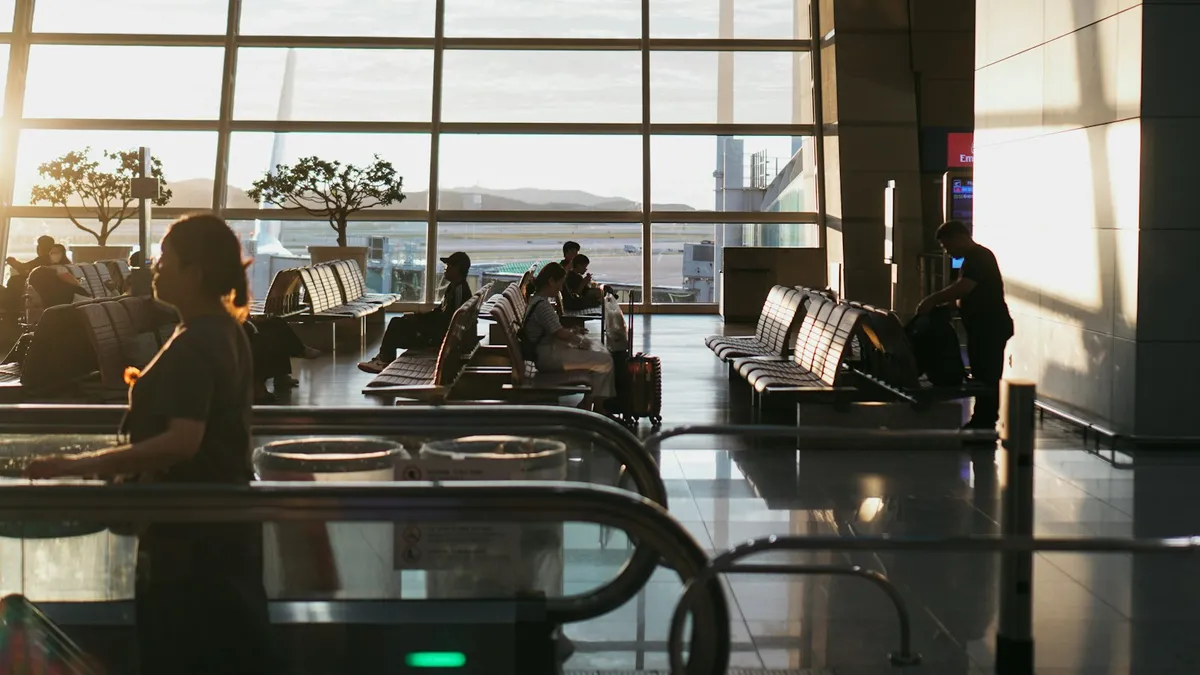 A man sitting in an airport waiting for his luggage